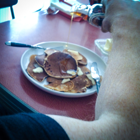 lockman place maple syrup on wild blueberry and chocolate chip pancakes. mmmmmmm.